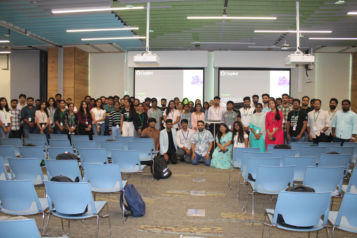 A group gathered in a lecture room beneath GitHub Copilot Dev Days screens.